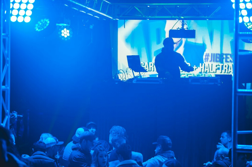 Television gallery with illuminated mixing desk and screens